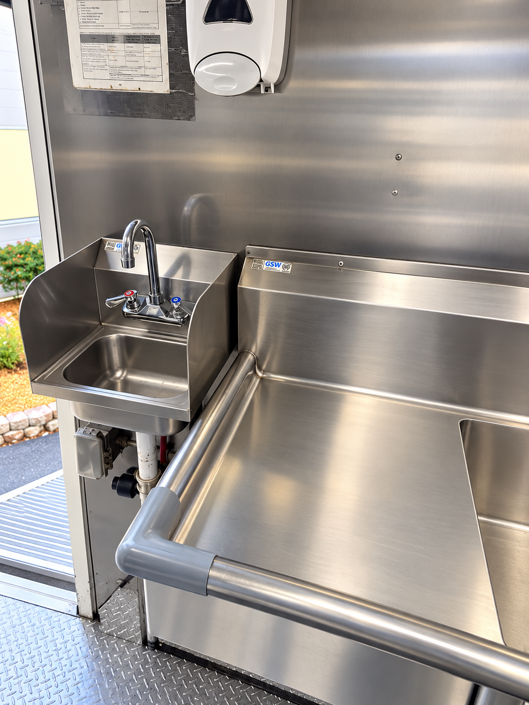 Stainless sink basins and work surface inside a mobile kitchen