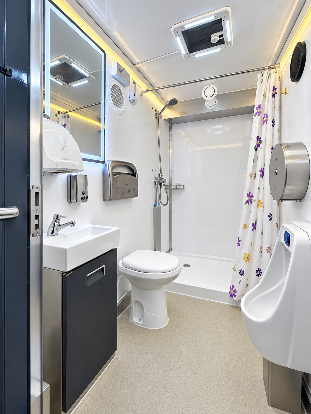 Shower, toilet, sink and urinal inside a mobile combination trailer