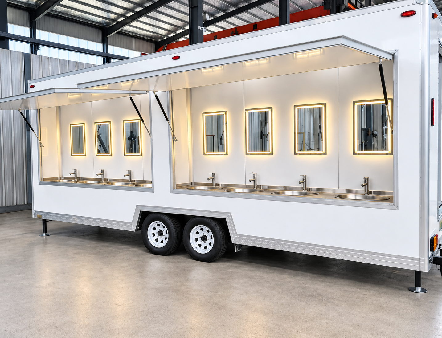 White handwashing trailer with multiple sinks below an open canopy