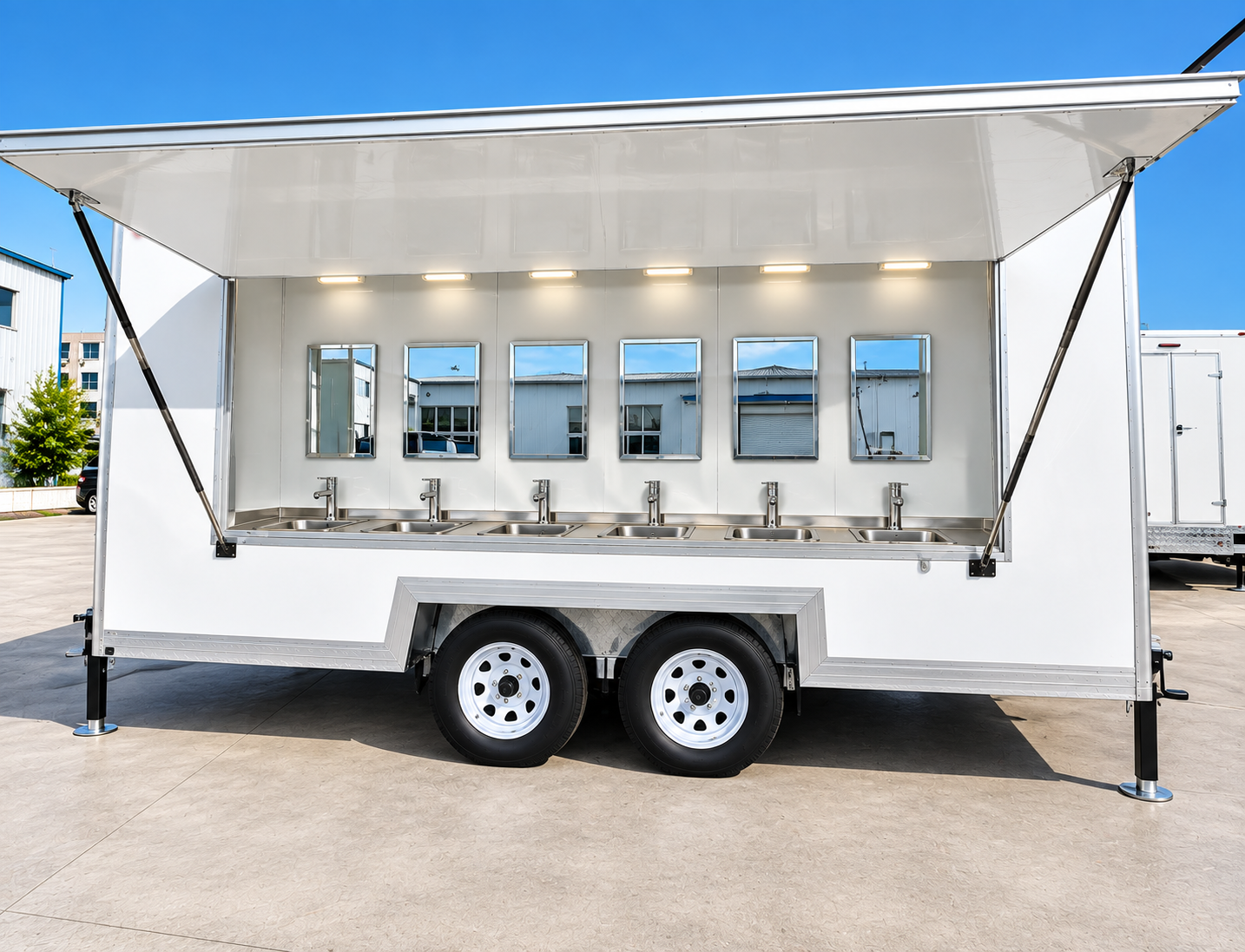 Exterior of a white trailer with six visible handwashing sinks