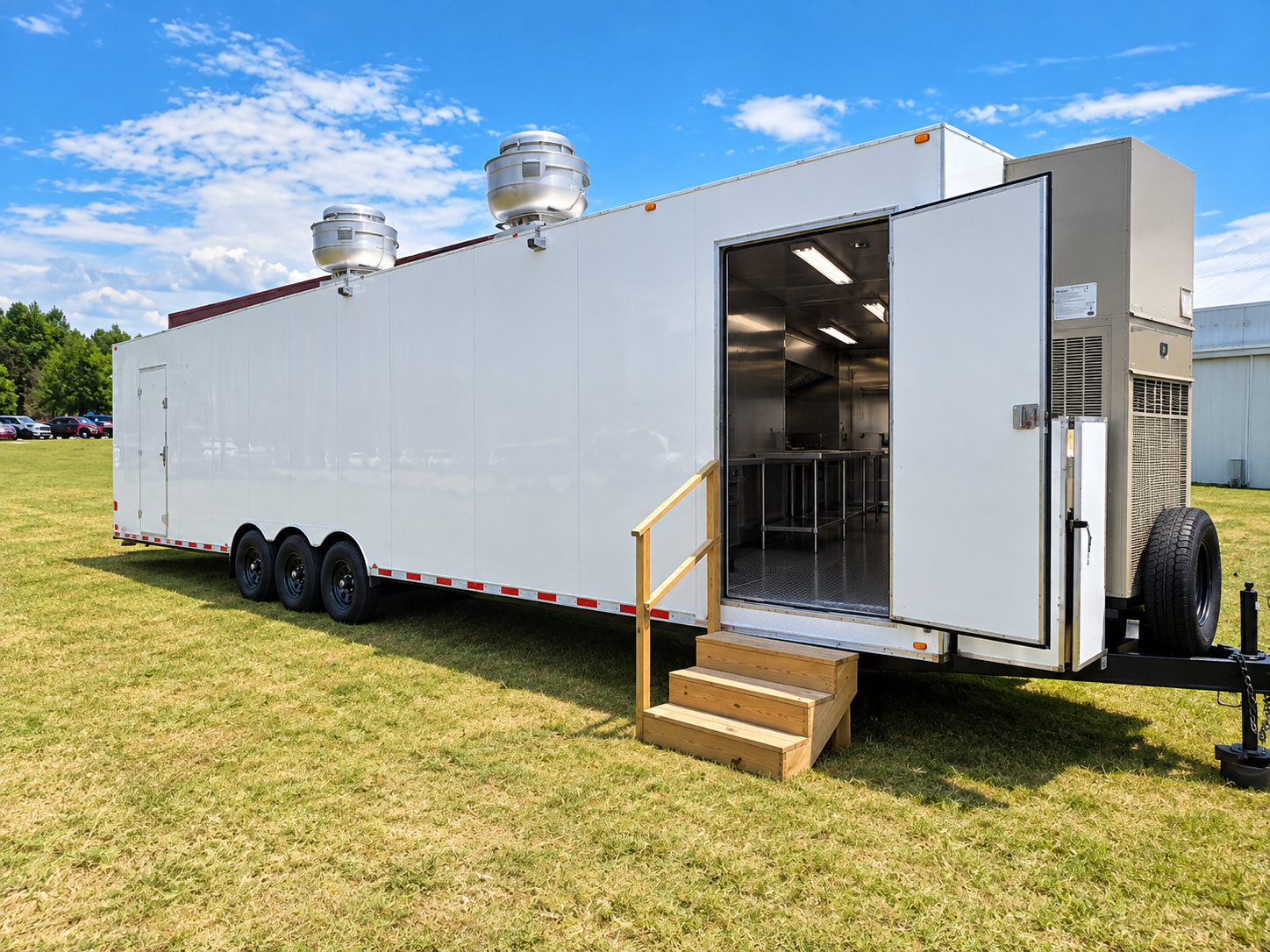 White mobile kitchen trailer with open entrance and steps