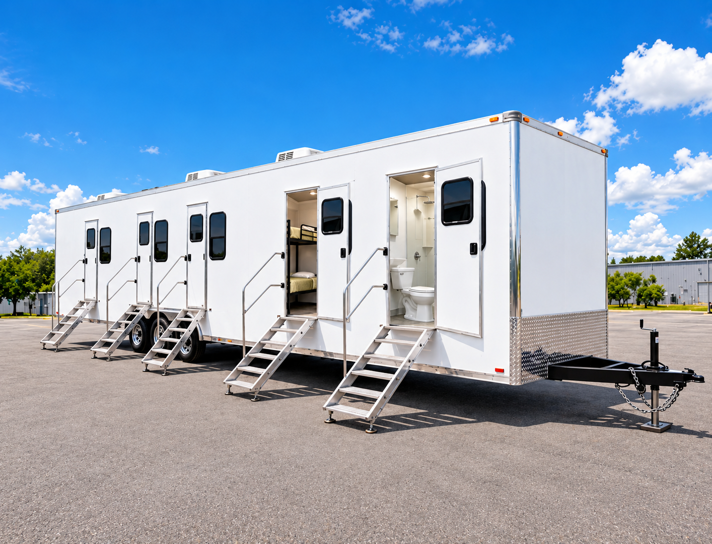 White trailer with separate room entrances, visible bunks and a restroom doorway